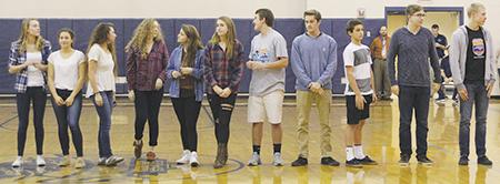 State-qualifying swimmers (from left) freshman Cecilia Cortez, senior Laura Maniet, senior Sarah Mandis, senior Morgan Gates, junior Olivia Kyger, sophomore Savannah Wallace, junior Byrde Wells, sophomore Bryce Pugh, sophomore Alan Maniet, sophomore Dagen Gilbreath and junior Hunter Crook are celebrated for their accomplishments at First Flight’s winter sports pep rally during Empower Time last month. PHOTO BY DEA CELAJ/NIGHTHAWK NEWS