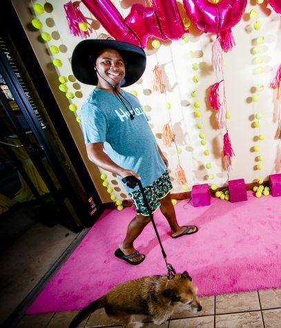 Showcasing birthday suit apparel, Southern Bank employee Omowalie "Wally" Isidore showcases his birthday suit apparel and show-dog Russell. 