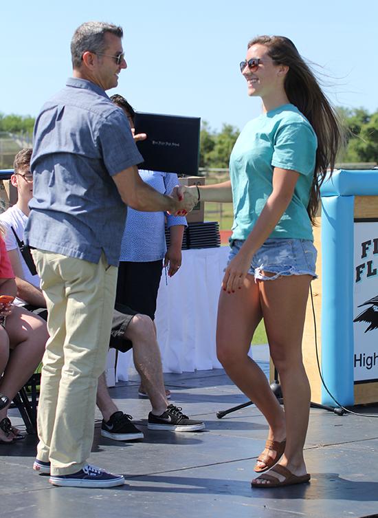 Arty Tillett laughs while working with seniors at graduation practice last week. Tillett presided over his final First Flight graduation and now will work out of the Dare County Schools central office.