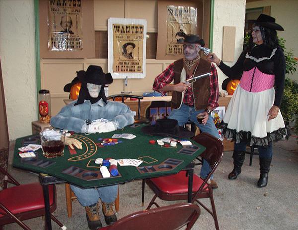 School finance officer Ron Cope gets into the Halloween spirit with neighbor Clare Strickler, a regular substitute teacher at First Flight. This haunted saloon is one of many impressive themes Cope has put on for trick-or-treaters in the famed First Street neighborhood. Photo submitted by Ron Cope