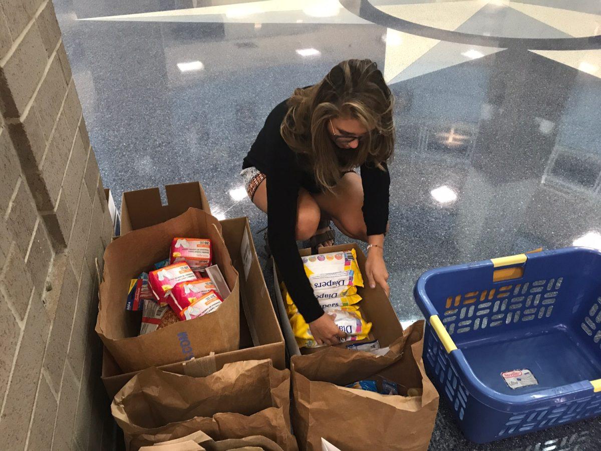 Senior Kira Foster spends time after school Monday going through a generous quantity of donated items brought in by a community group. Students are encouraged to stop by the rotunda before or after school to help victims of Hurricane Irma and earn Spirit Points at the same time. PHOTOS BY ARABELLA SAUNDERS/NIGHTHAWK NEWS