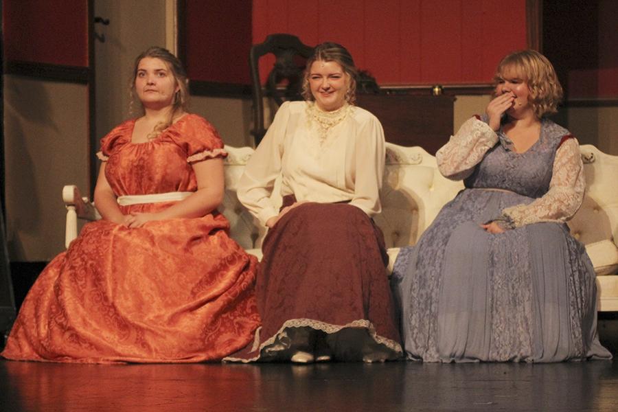 Chloe Futrell (from left), Summer Tonnesen and Grace Hook share a light-hearted moment on the couch during a dress rehearsal for 'Pride and Prejudice.' PHOTO BY PAYTON GADDY/Shorelines Yearbook