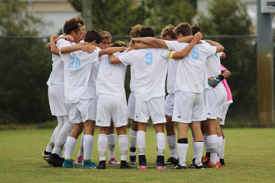 Members of the soccer team huddle up before a game earlier this season. The Nighthawks play host to Currituck for Senior Night on Wednesday. PHOTOS BY HAYLEY MILLER/SHORELINES and MICHAELA KELLY/NIGHTHAWK NEWS