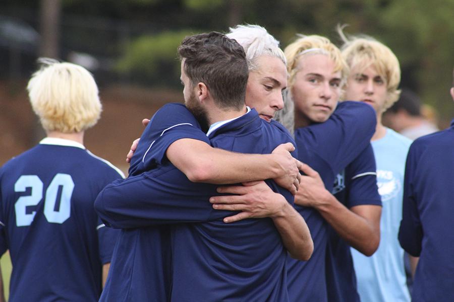 Assistant coach Joel Mount hugs players at the conclusion of Saturday's 1-0 loss in the title game against Newton-Conover. PHOTO BY MICHAELA KELLY/Nighthawk News Magazine