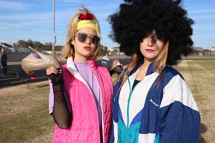 Junior Suki Holian (left) and senior Casey Bouker pose in their 1980s attire while helping classmates film a video to promote this week's NHS Dance-a-Thon. The event takes place Saturday, Feb. 24. PHOTO BY CODIE PATTERSON