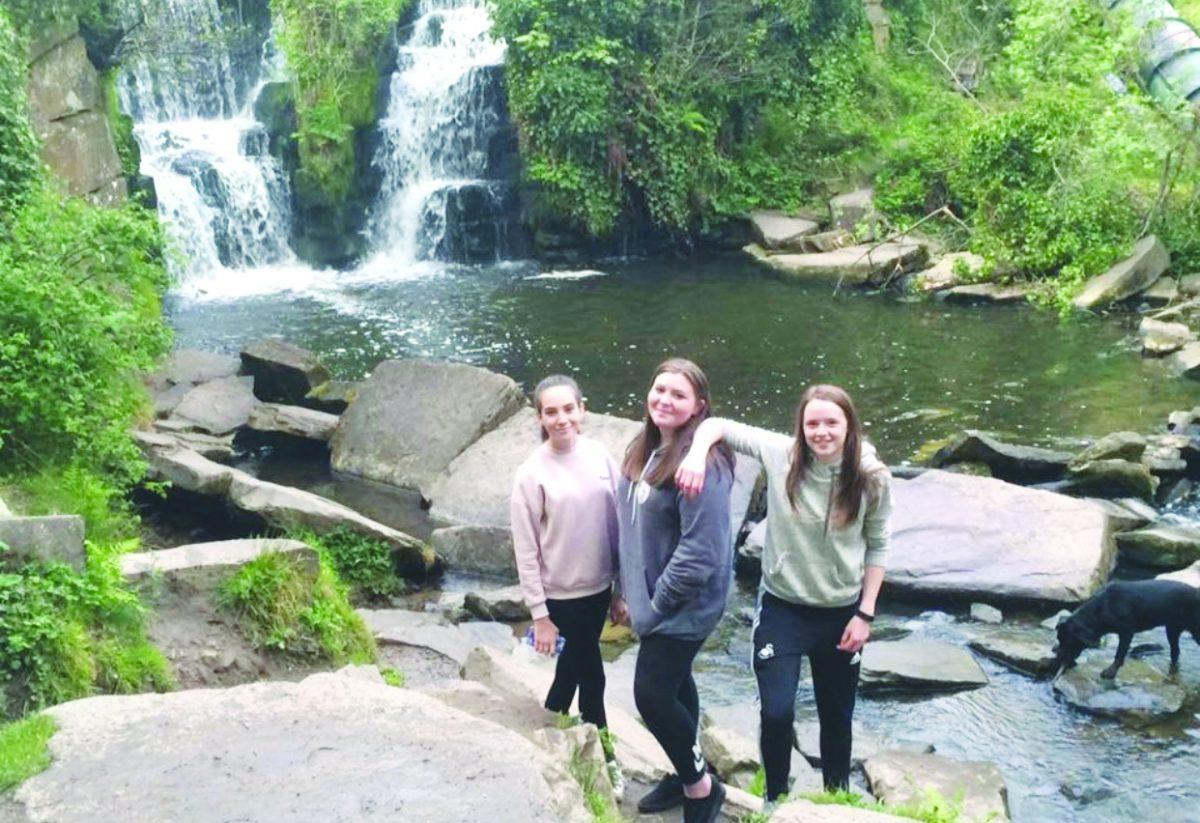 Junior Maddie Bell (left) stands with her friends from Wales enjoying a good time at the Penllergare Valley Woods Waterfall in the United Kingdom. Bell misses her friends dearly but is excited to make new memories with new friends on the Outer Banks. PHOTO SUBMITTED BY MADDIE BELL