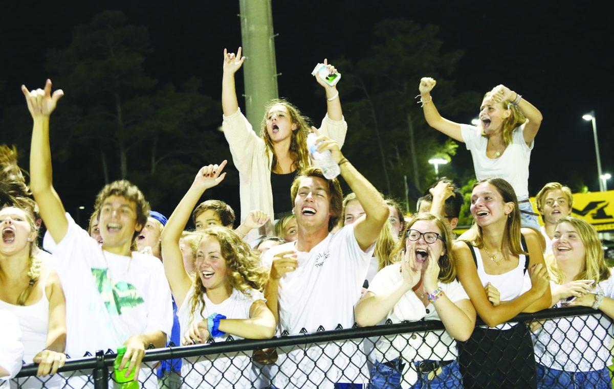 (From left) Sophomore Skylar Graham and seniors Kaitlyn, Stanton Dodson, Grace Sullivan and Caroline Jenkins cheer for the Nighthawks at the Marlin Bowl. Etiquette in the stands is just as important as the numbers on the scoreboard. PHOTO BY MADISON MURRY / Shorelines Yearbook
