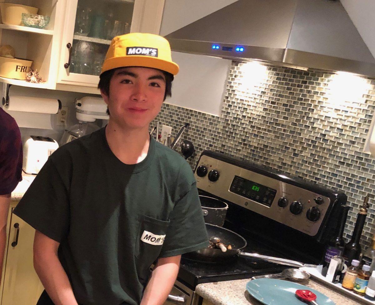 Sophomore Max Stabley stands in his kitchen as he finishes preparing dinner. Stabley has a passion for cooking and is known for his food Instagram account. PHOTO SUBMITTED BY / Max Stabley