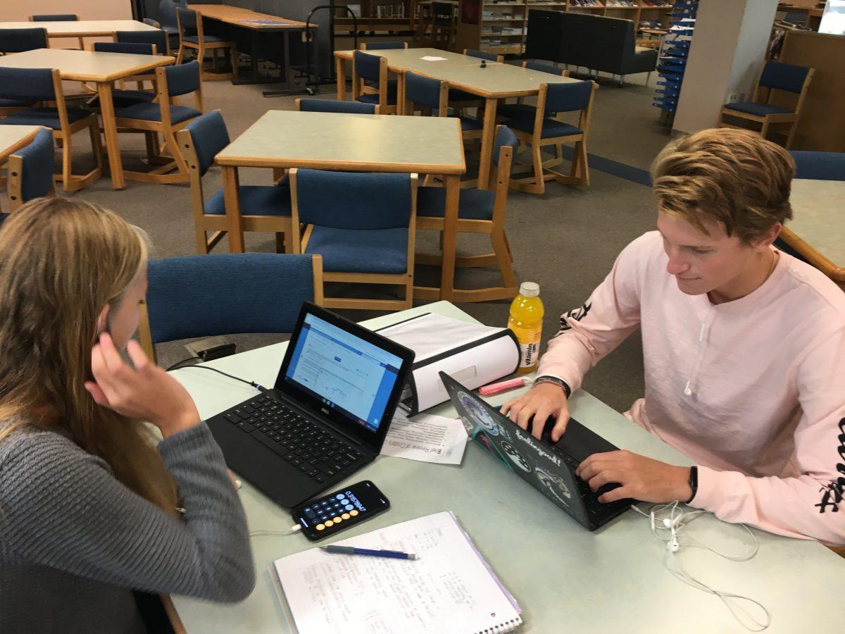 Seniors Myles Sillies and Ashlynn Dodge work on assignments in the media  center. They are just a couple of the many students who will be adjusting to the new Empower Time schedule.