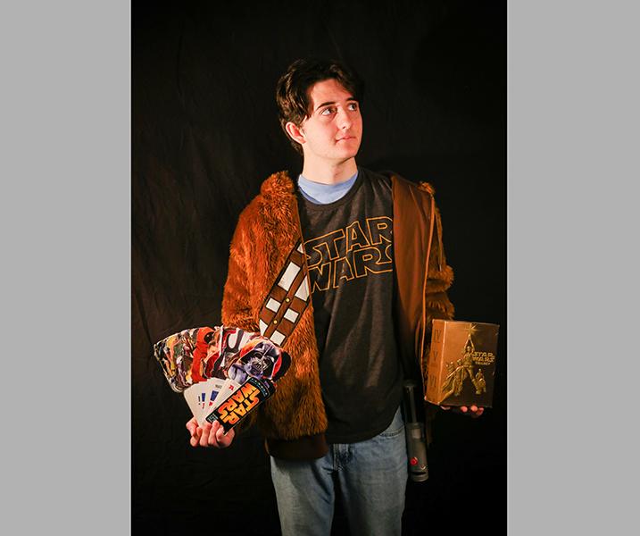 Junior McRae Walker poses with his wide array of ‘Star Wars’ memorabilia. Especially with Disney now in charge, new items flood the market with every new release. PHOTO ILLUSTRATION BY TAYLOR NEWTON/Nighthawk News