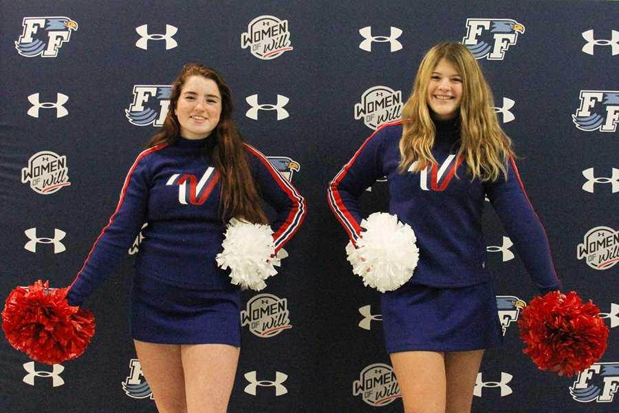 Sophomores Virginia Godley and Emily Byrum try out their All-American Cheer uniforms. The Nighthawks will perform in the London New Year’s Day parade with other cheerleaders from all over the world for a huge audience in this annual tradition. PHOTO BY CALLIE HONEYCUTT/Nighthawk News