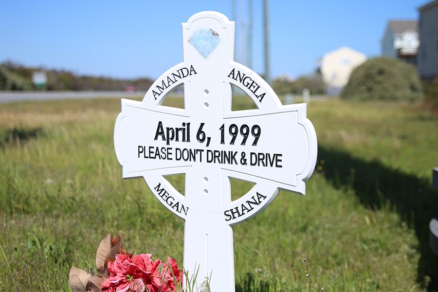 A cross remembering the four 17-year-olds who were killed at the Colington/bypass intersection reminds people of the dangers of drunk driving. PHOTO BY MICHAEL PEARSON/Nighthawk News