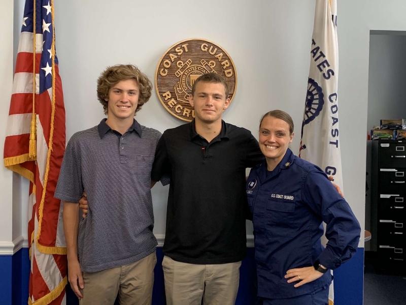 Seniors Barritt Grizzard (left) and Dean Torchia visit with a Coast Guard recruiter in Chesapeake after signing up to serve. PHOTO SUBMITTED BY BARRITT GRIZZARD