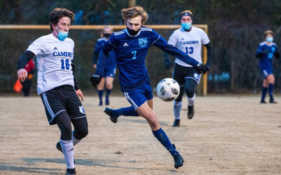 Senior Tanner Bouker chases down the ball earlier in the 2021 soccer season, which is completely different than most. PHOTO BY TAYLOR NEWTON/Nighthawk News
